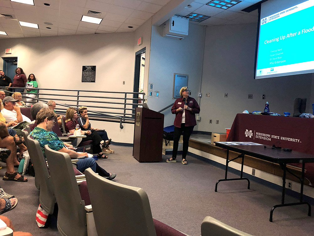 An MSU Extension agent gives presentation to audience.