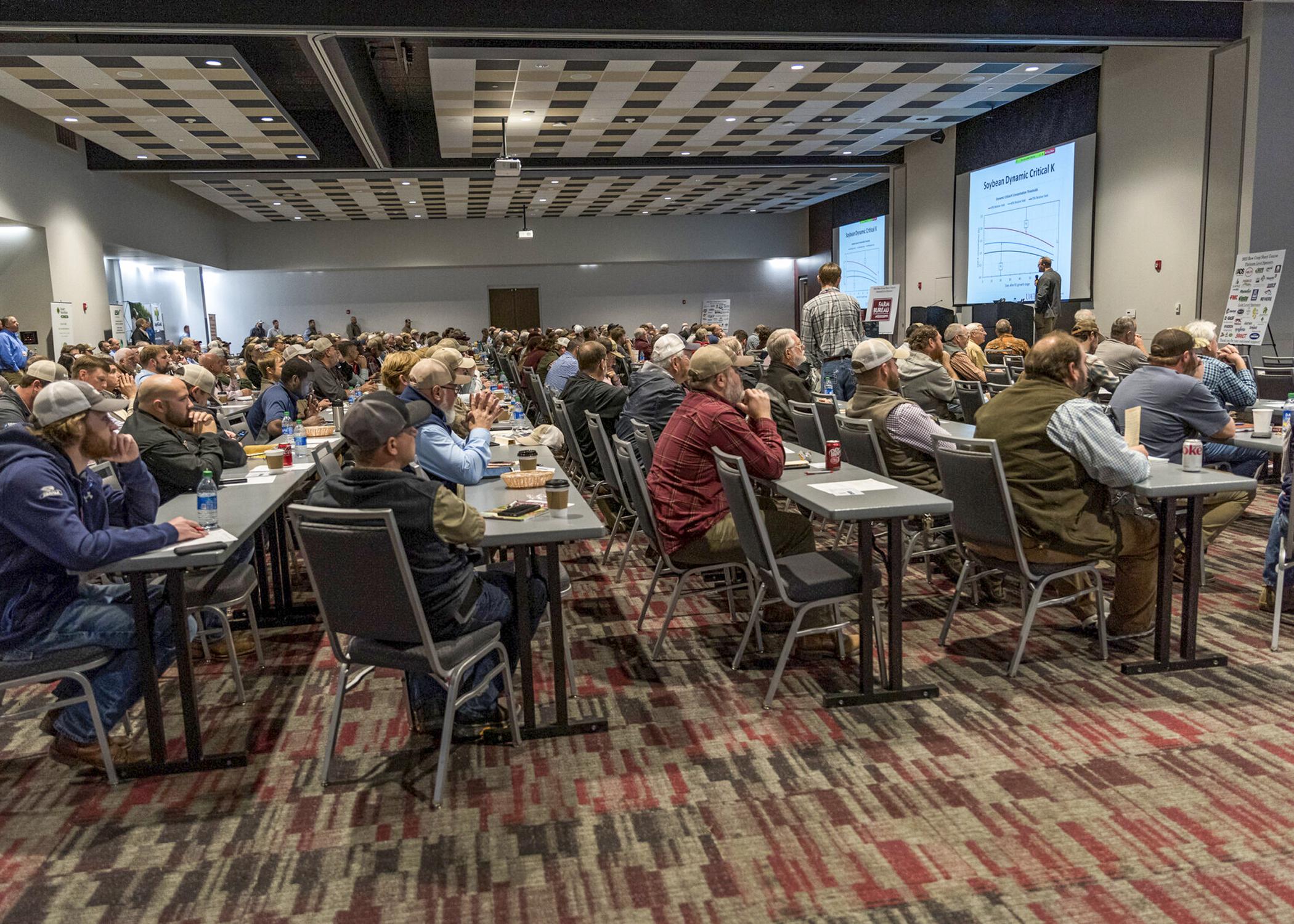 A large room full of people watching a presentation.