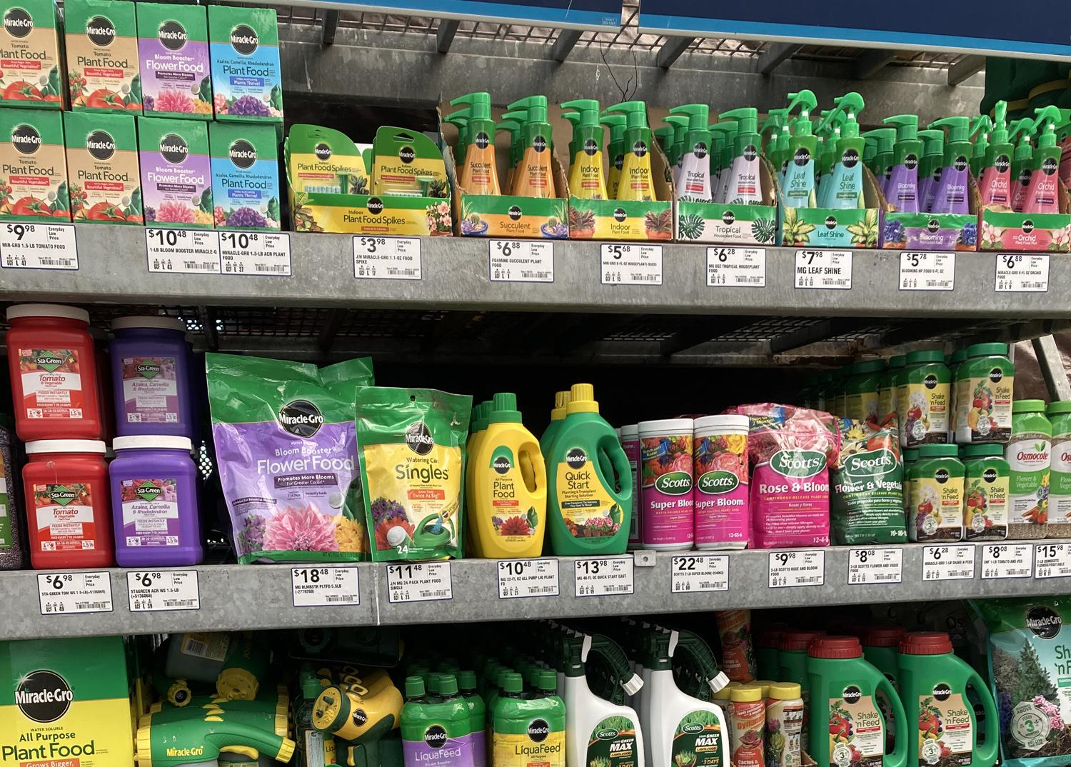 Bottles and bags fill a row of shelves in a store.