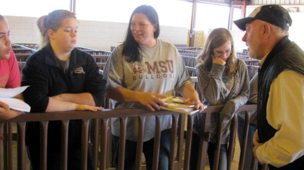 A teacher and four female students.