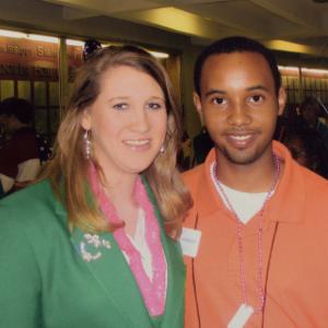 A teen boy and teen girl, both smiling.