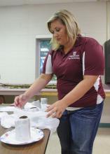 Kandiace Gray, a Mississippi State University graduate student from Fulton, prepares materials for workshop on growing mushrooms, mosses and ferns on July 8, 2014 at Dorman Hall on the Starkville campus. (Photo by MSU Ag Communications/Kevin Hudson)