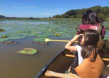 Simply taking children outside will open their eyes and hearts to the outdoors. While canoeing with adults on Bluff Lake in Noxubee County, Mississippi, this child searched for alligators and birds with her binoculars. (Photo by MSU Extension Service/Evan O’Donnell)