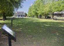 A rectangular grassy area is lined with marker posts.