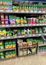 Bottles and bags fill a row of shelves in a store.