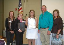 Mississippi State University junior and agribusiness major Joanna King, center, of Yazoo County, receives the Mississippi Women in Agriculture-Dianne Evans Memorial Scholarship during the 2013 Mississippi Women in Agriculture Conference Feb. 28 in Raymond. Pictured with King, from left, is Mississippi Women in Agriculture President Sherilyn Jones; Mississippi Commissioner of Agriculture and Commerce Cindy Hyde-Smith; and Dianne Evans' children, Robert Evans and Deena Evans Lowery. (Photo by MSU Ag Communica