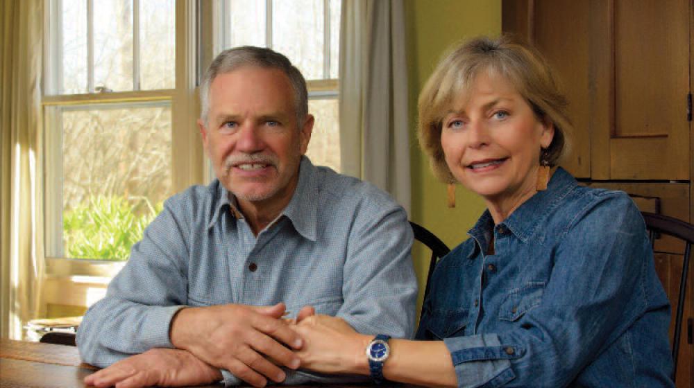 A man and woman sit at a table.