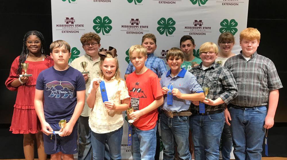 Group of children standing together for group picture holding their awards from Project Achievement Day