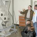 Natasha Hunter, kneeling, and fellow high school students Allen Robinson and Kristy Poole watch cotton move through a mini-gin at Mississippi State University as Eugene Columbus, a senior research associate with MSU's agriculture and biological engineering department, explains the process. The agriscience survey students visited the only operational gin on a college campus during a recent field trip.