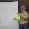 Ray Welch, owner of Winona Stockyards, serves as the auctioneer for the Cattlemen's Exchange and Homeplace Producer Sale held in April. Buyers see video segments and read descriptions of cattle lots as they bid on the animals. More than 2,000 cattle were sold in less than an hour with total receipts approaching $1.9 million. (Photo by Linda Breazeale)