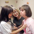 Abby Matthews of Summit listens to Debra Ann Breazeale's heartbeat on June 5, 2012, as Starkville pediatrician Dr. Deborah Shirley oversees. Matthews is participating in the five-week Rural Medical Scholars program at Mississippi State University. (Photo by MSU Ag Communications/Kat Lawrence)