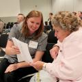 Casey Coleman of Tupelo and Patricia Pendergrass of Louisville review the agenda while waiting for the beginner beekeeper workshop to begin Friday, Oct. 26, 2012, at the annual Mississippi Beekeepers Association conference, held at Mississippi State University. (Photo by MSU Ag Communications/Keri Collins Lewis)