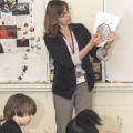 Leslie Burger, an environmental educator with the Mississippi State University Extension Service, teaches fourth graders at Starkville's Henderson Ward Stewart Intermediate School how to determine a tree's age based on its growth rings. (Photo by MSU Ag Communications/Scott Corey)