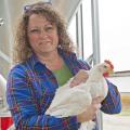 Delean Robertson holds one of her chickens at her poultry farm, Straight Arrow Farm in McComb. Robertson is a member of Mississippi Women for Agriculture and strives to educate others about women's important role in the agriculture industry. (Photo by MSU Ag Communications/Kat Lawrence)