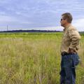 Guy Ray, president of Pleasant Lake Plantation, looks over grasslands on the property on July 31, 2014. He has implemented numerous conservation land management practices to make the Leflore County, Mississippi, plantation a model of sustainability and functionality. (Photo by MSU Ag Communications/Kevin Hudson)