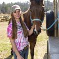 Millie Thompson of Starkville grooms her horse, Snip, before riding on Feb. 11, 2015. Thompson is preparing for the 2015 Mississippi 4-H Equine Shadow Program taking place in conjunction with the Dixie National Quarter Horse Show Feb. 16-22 in Jackson. (Photo by MSU Ag Communications/Kevin Hudson)