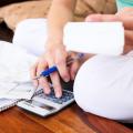 Closeup of a woman budgeting personal finances.