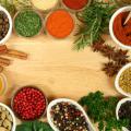 Closeup of herbs and spices on a cutting board.