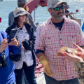 Man showing fish to group