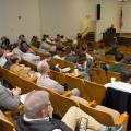 People in an auditorium watching a person give a presentation.