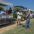 A peanut agronomist shows a group of people a disease-infested peanut plant.