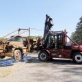 A staff member from Taylor Machine Works lifts a 1948 log loader to transport it to the company's Louisville, Miss., headquarters for restoration.  (File Photo by MSU Forest Operations/Misty Booth)