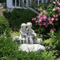 This sculpture  is surrounded by Giant Pink Supertunia and white variegated dianella behind and Big Blue Liriope.