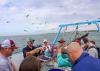 Mississippi State University Extension marine fisheries specialist Marcus Drymon shows a trawl-caught cutlassfish to fishermen during a 2022 field excursion. (Photo by MSU Extension/Marine Fisheries Ecology)