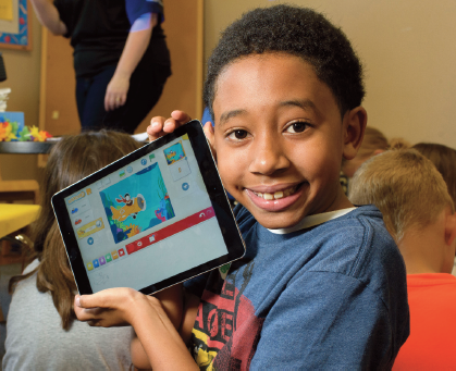 A 4-H Junior Robotics holding a tablet.